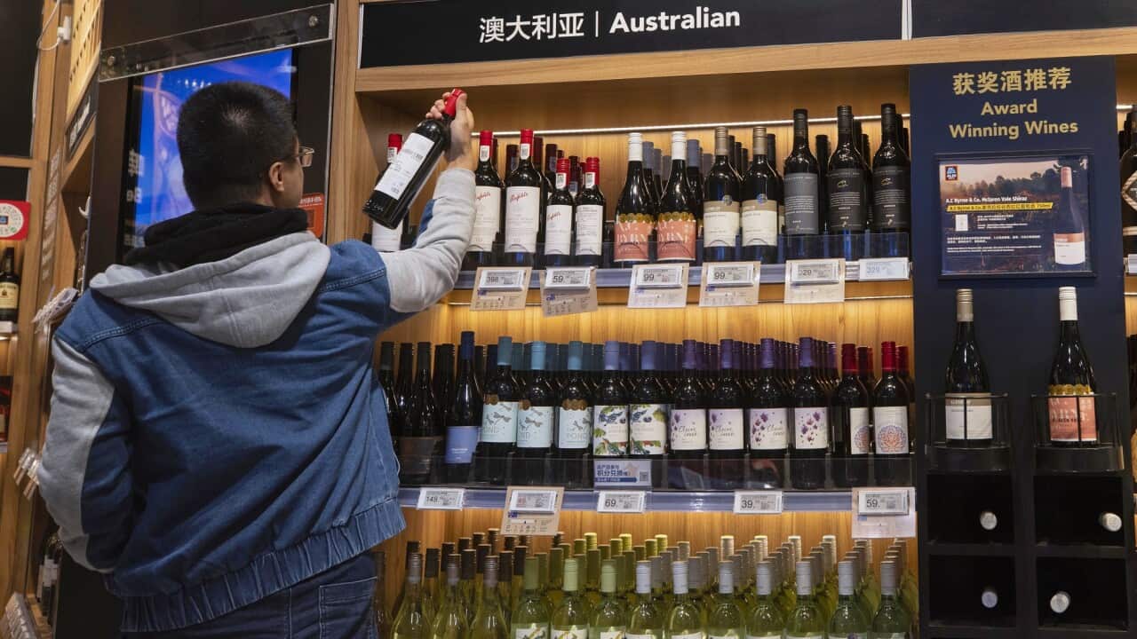 A man examines Australian wine in Shanghai, China.