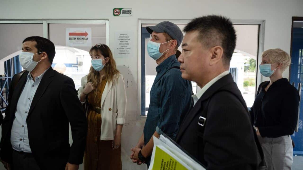 Australian Al Jazeera journalists, reporter/senior producer Drew Ambrose (L), cameraman Craig Hansen (C) and producer Jenni Henderson (R), involved in a documentary about the arrests of undocumented migrants, arrive at the Bukit Aman police headquarters i