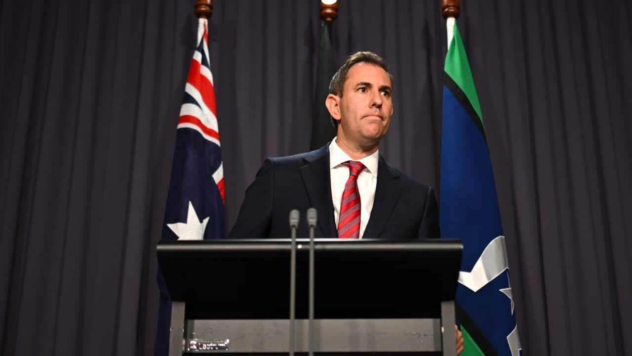 Jim Chalmers speaking at a podium