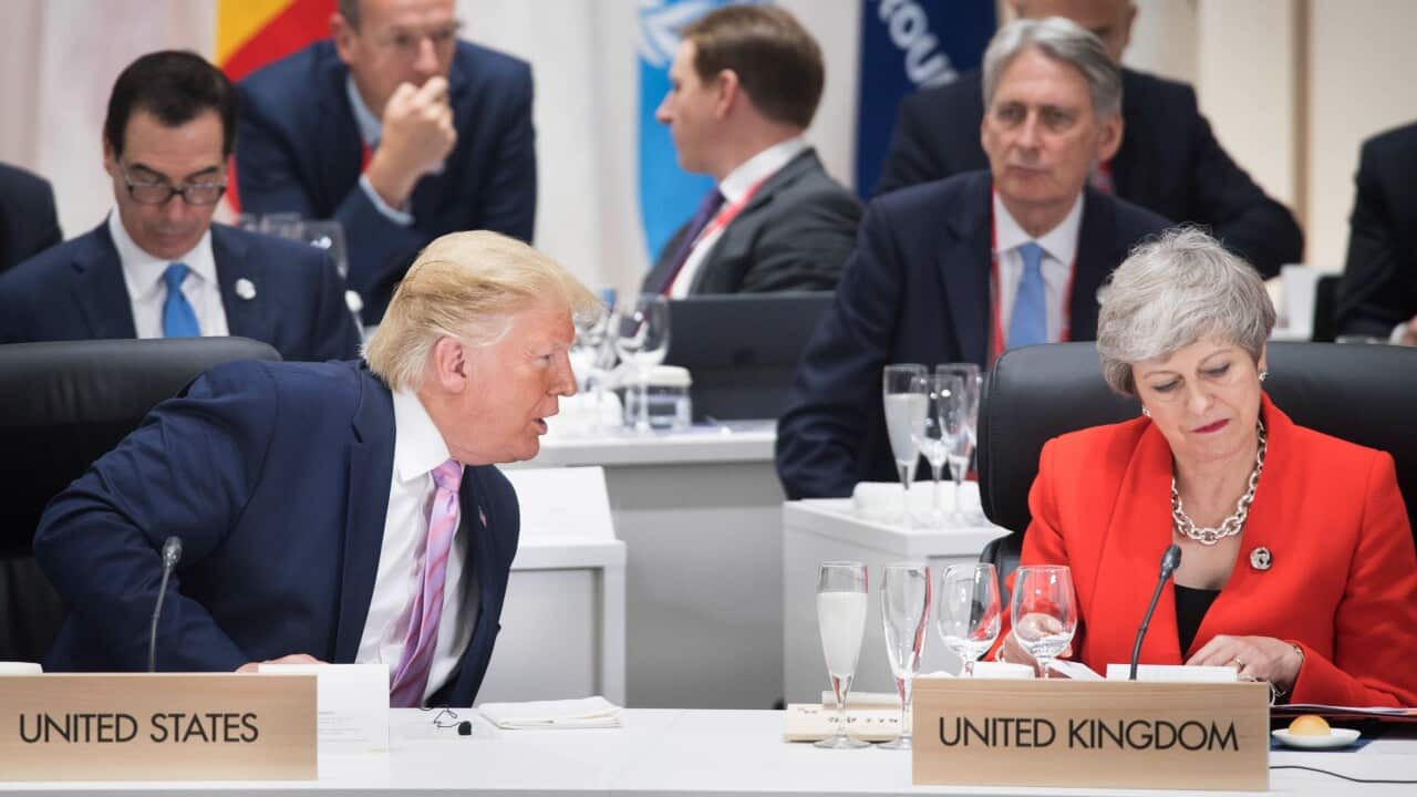 US President Donald Trump chats with British Prime Minister Theresa May at the first working session of the G20 Summit in Osaka