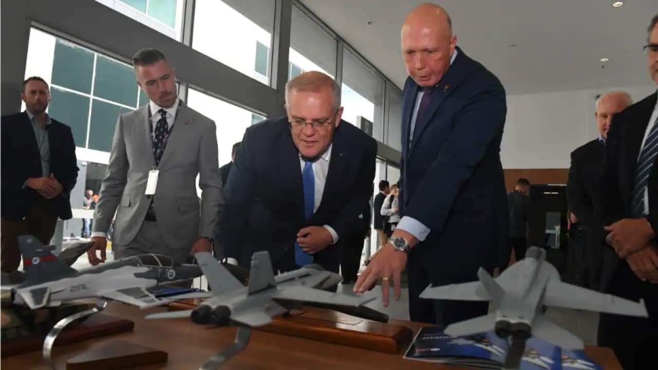 Defence Minister Peter Dutton (right) has suggested that China could be using bribes to increase its international influence.