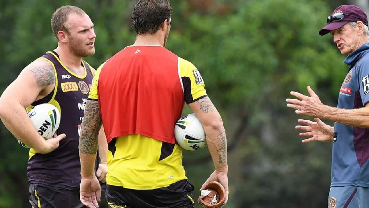 Matt Lodge and Korbin Sims speak with coach Wayne Bennett.