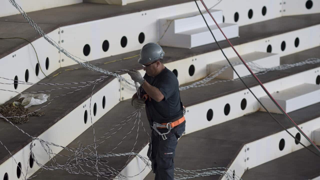 A worker inside the Olympic Aquatic Stadium in Rio de Janeiro, Brazil