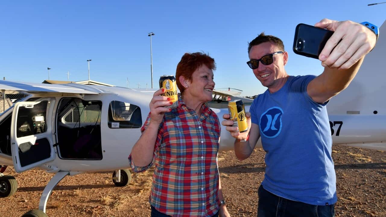 One Nation leader, Senator Pauline Hanson (left) and her political advisor James Ashby pose for a photograph in Birdsville.