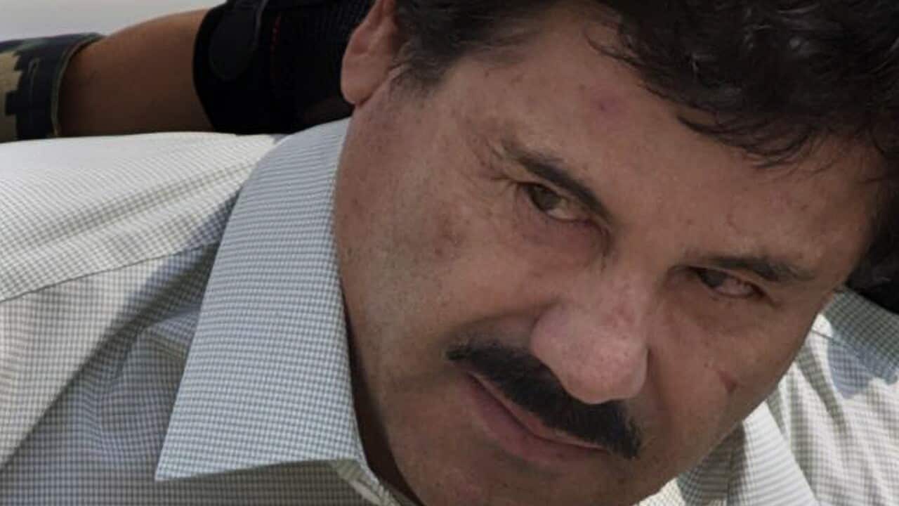 Joaquin "El Chapo" Guzman is escorted to a helicopter in handcuffs by Mexican Navy marines at a navy hanger in Mexico City