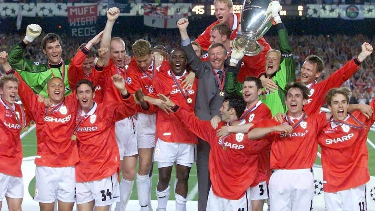 Manchester United manager Alex Ferguson and his team lift the UEFA Champions League trophy in Barcelona, Wednesday 26 May 1999.