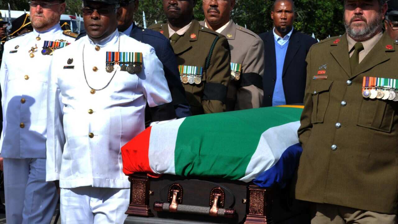 Military officers accompany Nelson Mandela's casket in Qunu