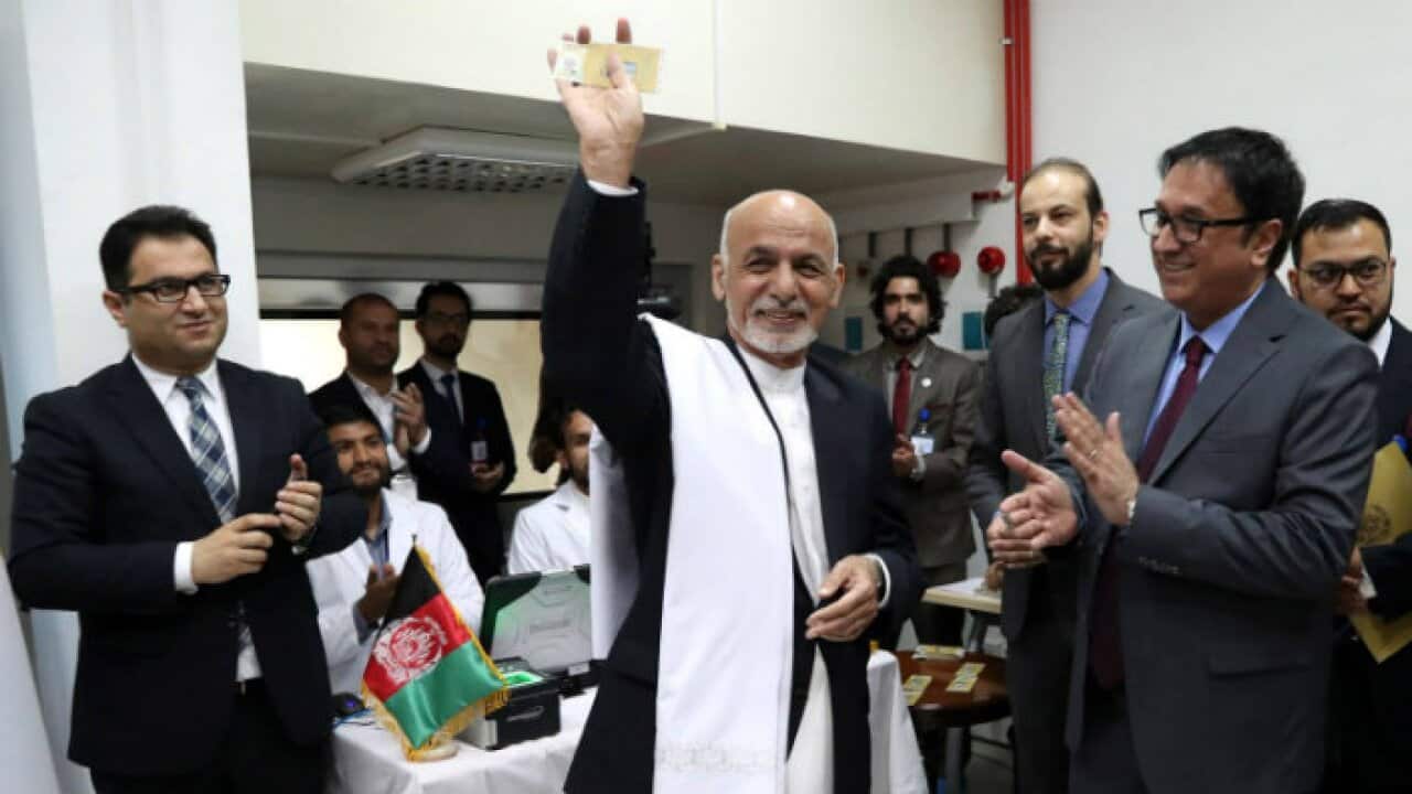 Afghan President Mohammad Ashraf Ghani receives his first electronic ID card