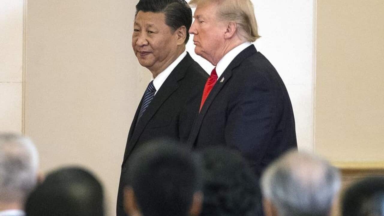 US President Donald J. Trump (R) and Chinese President Xi Jinping