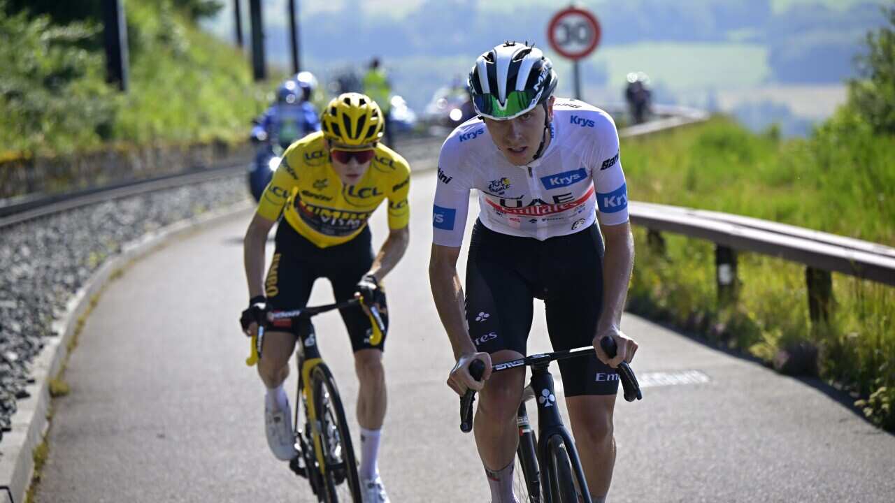 White Jersey best young rider Slovenian rider Tadej Pogacar (R) of team UAE Team Emirates and Yellow Jersey overall leader Danish rider Jonas Vingegaard of team Jumbo-Visma in action on the ascent of Puy de Dome during the 9th stage of the Tour de France 2023.