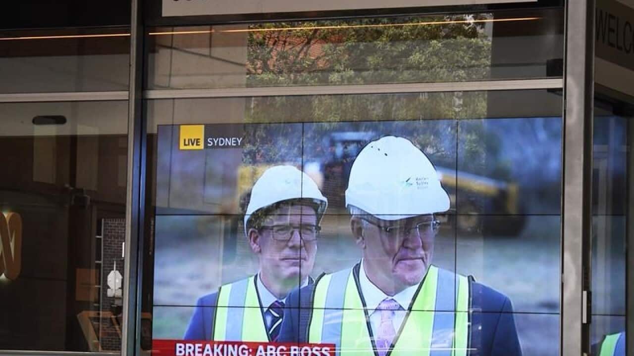 Scott Morrison is seen on a television screen showing ABC News 24