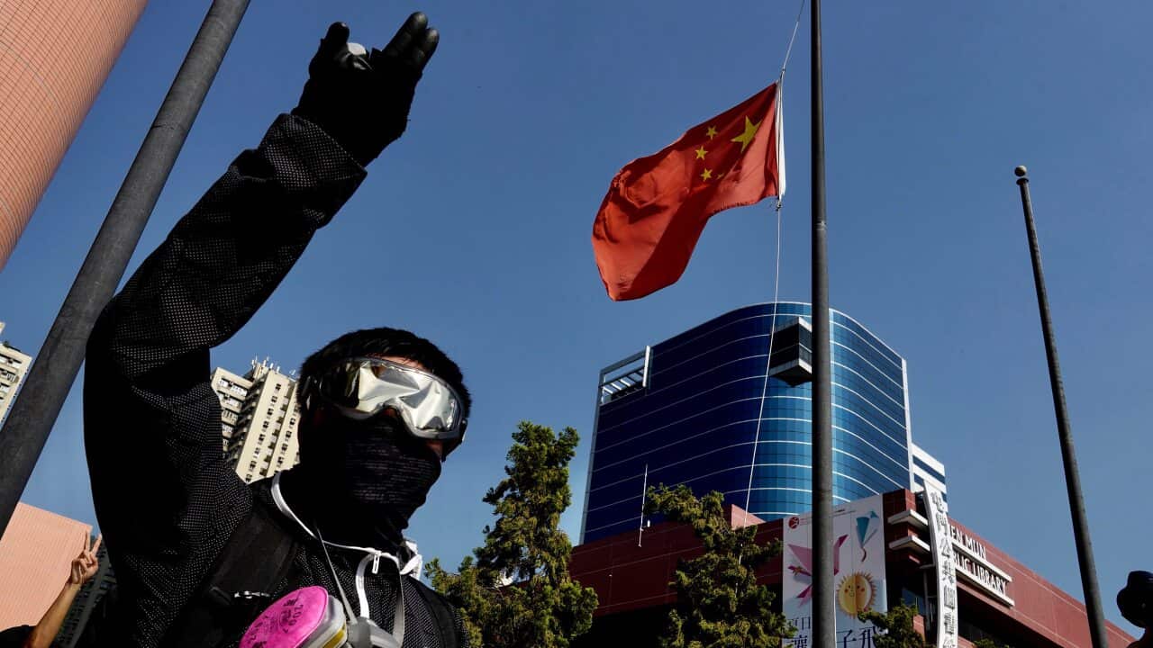 Protesters lower a Chinese national flag which they later set on fire in Hong Kong.