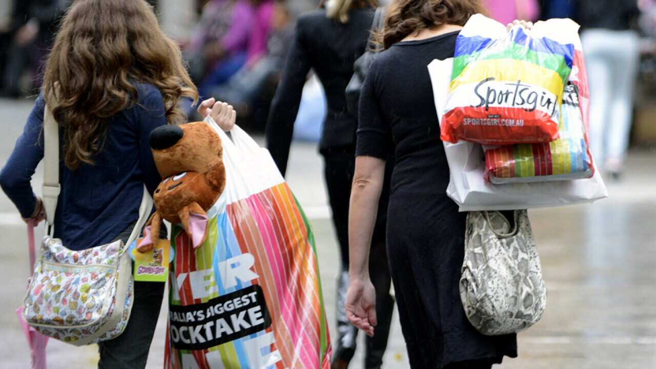 Women carry shopping bags at Queens Street Mall in Brisbane