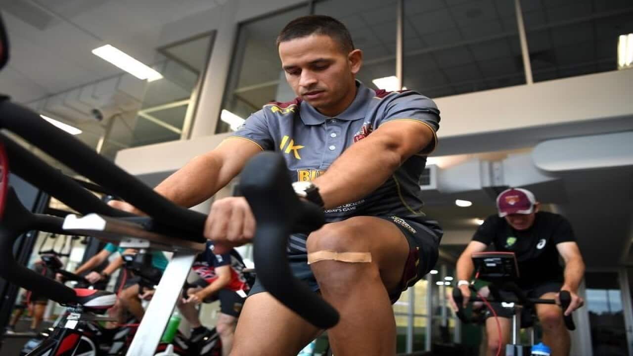 Usman Khawaja is seen on an exercise bike