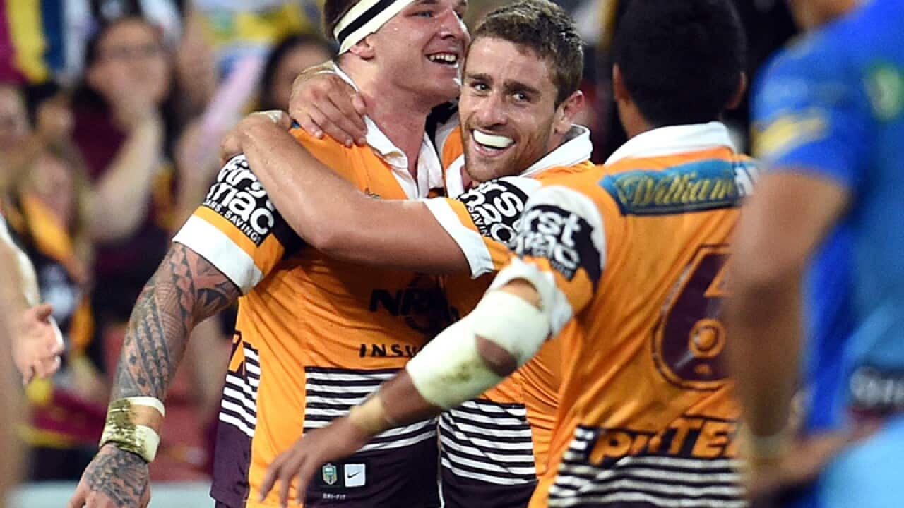 Brisbane Broncos players Andrew McCullough (C) and Josh McGuire (L)