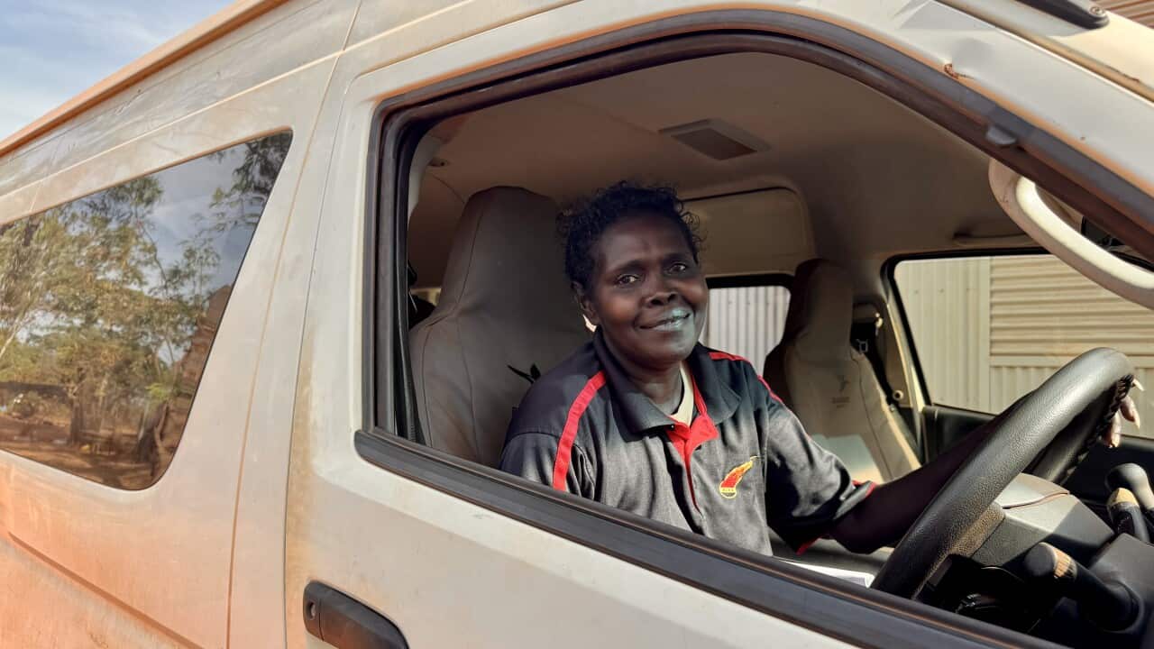 Vanessa Maymuru sitting in a van drivers seat wearing an ALPA polo uniform 