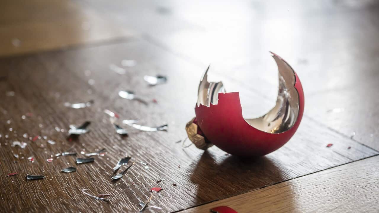 Shards of a shattered Christmas bauble on the floor
