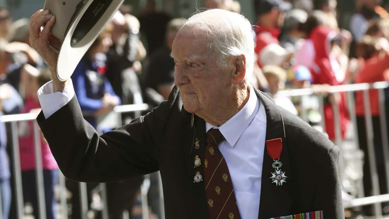 A war veteran tips his hat to the crowd