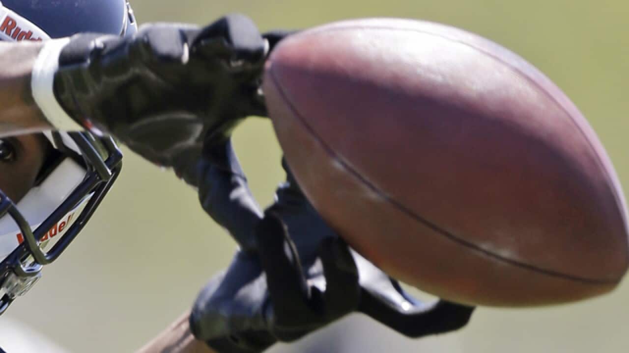 A footballer passes a ball