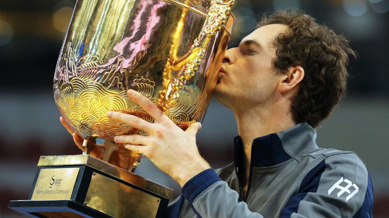 Andy Murray of Britain kisses the championship trophy in Beijing