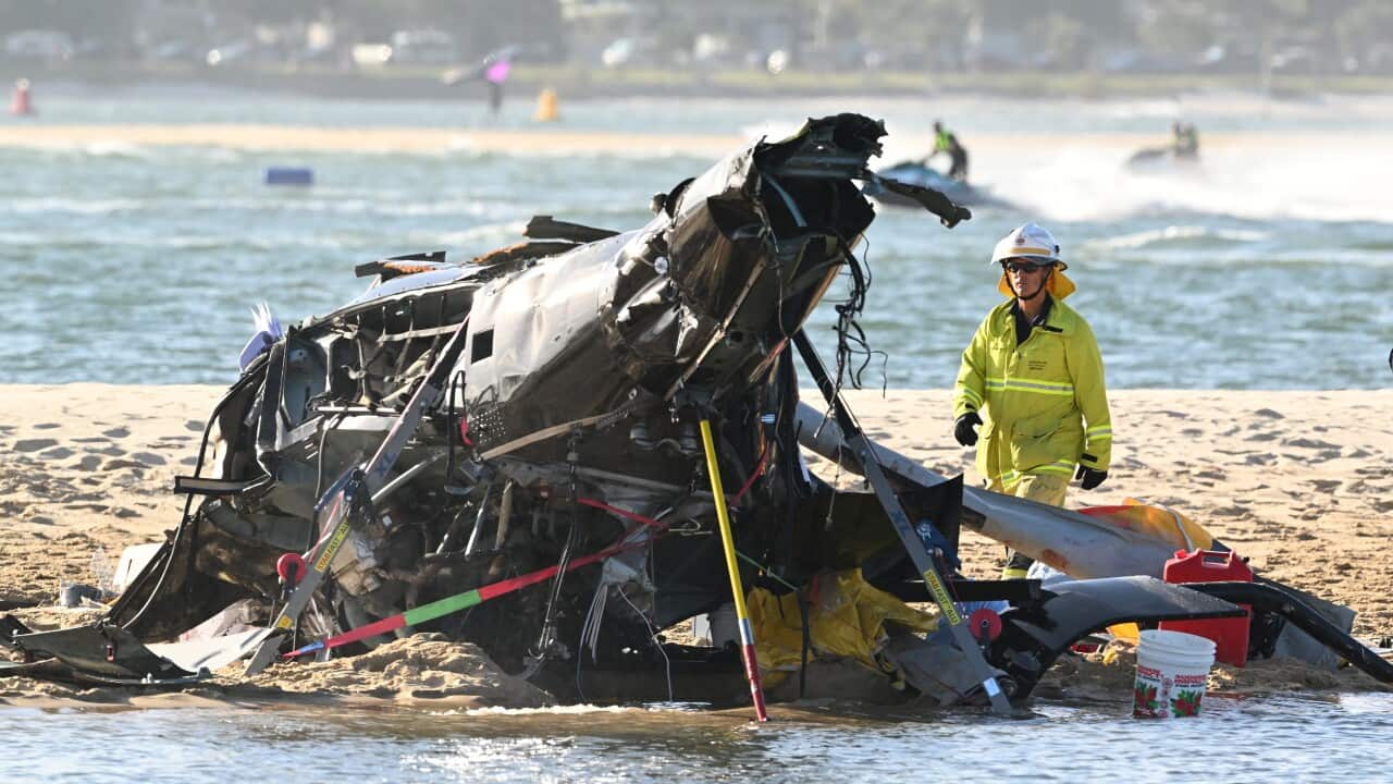 The wreckage of a helicopter is seen following the collision near Seaworld, on the Gold Coast