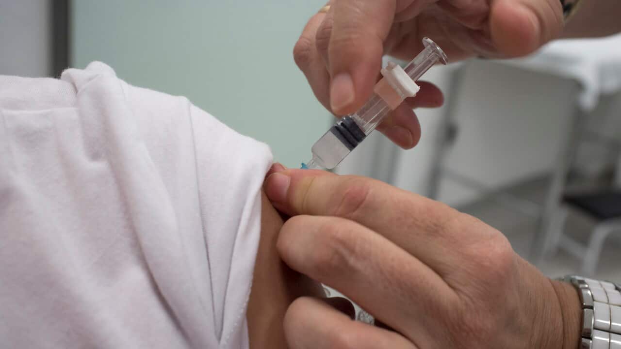 Nurse vaccinating little girl at Healthcare Center