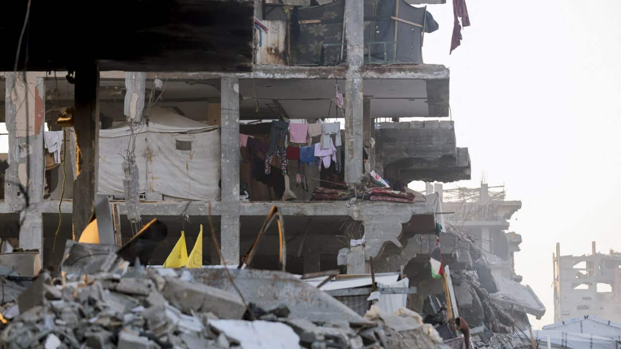 A view of a partially destroyed building among the rubble.