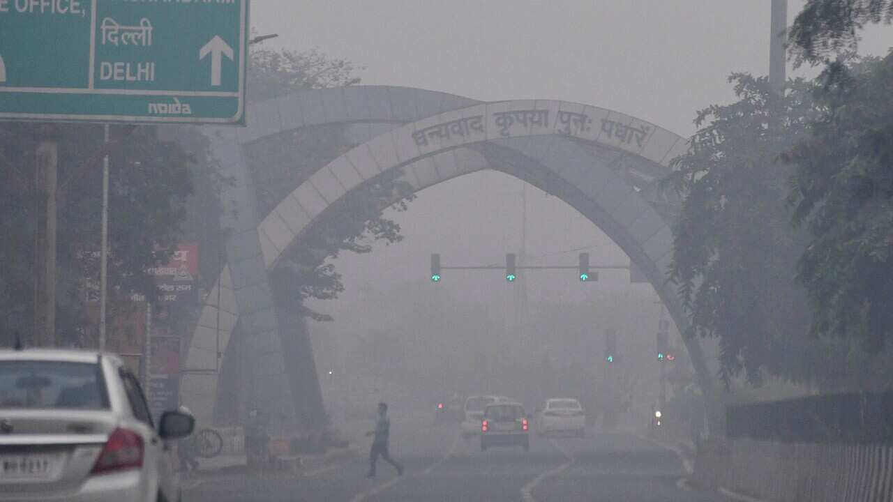 Vehicles ply on a road amid heavy smog, at Noida- Delhi Border