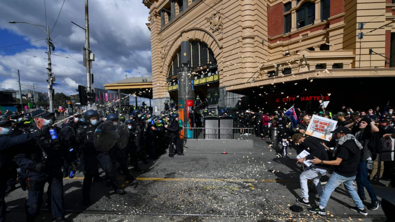 Protesters are pepper sprayed by police during an anti-lockdown protest in Melbourne on 21 August 2021.