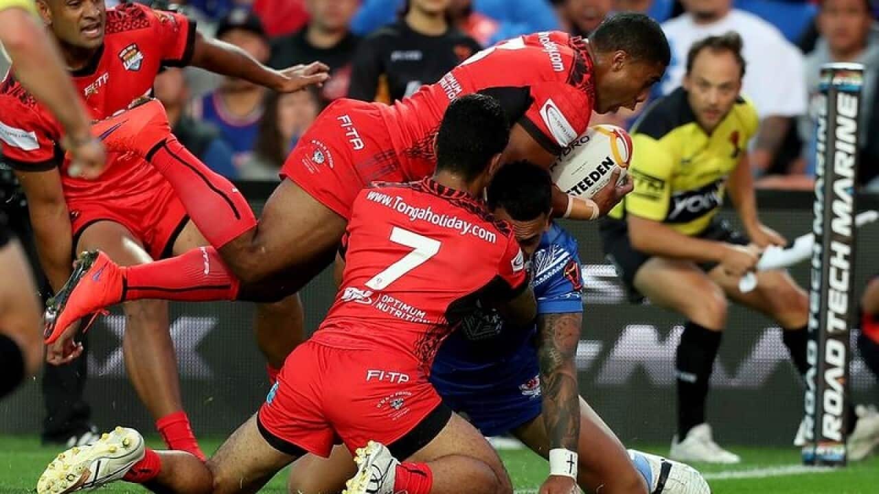 Michael Jennings of Tonga score a try during RLWC.