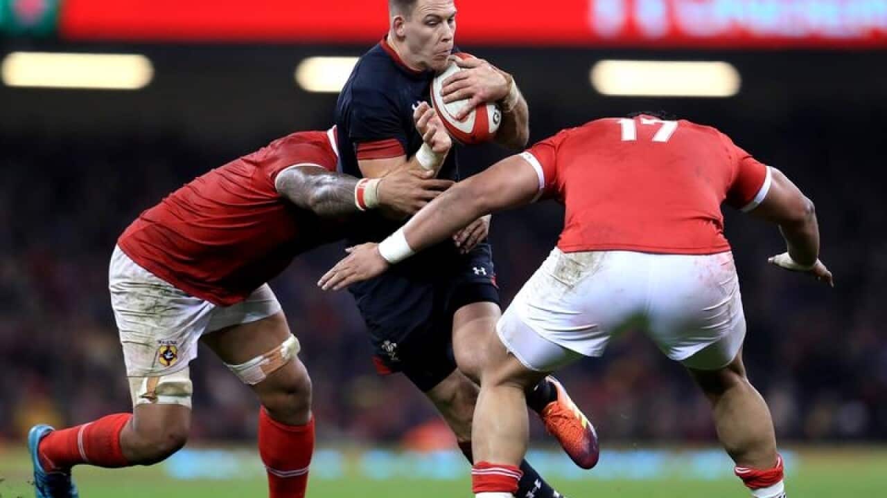 Liam Williams is tackled by Latu Talakai and Leva Fifita