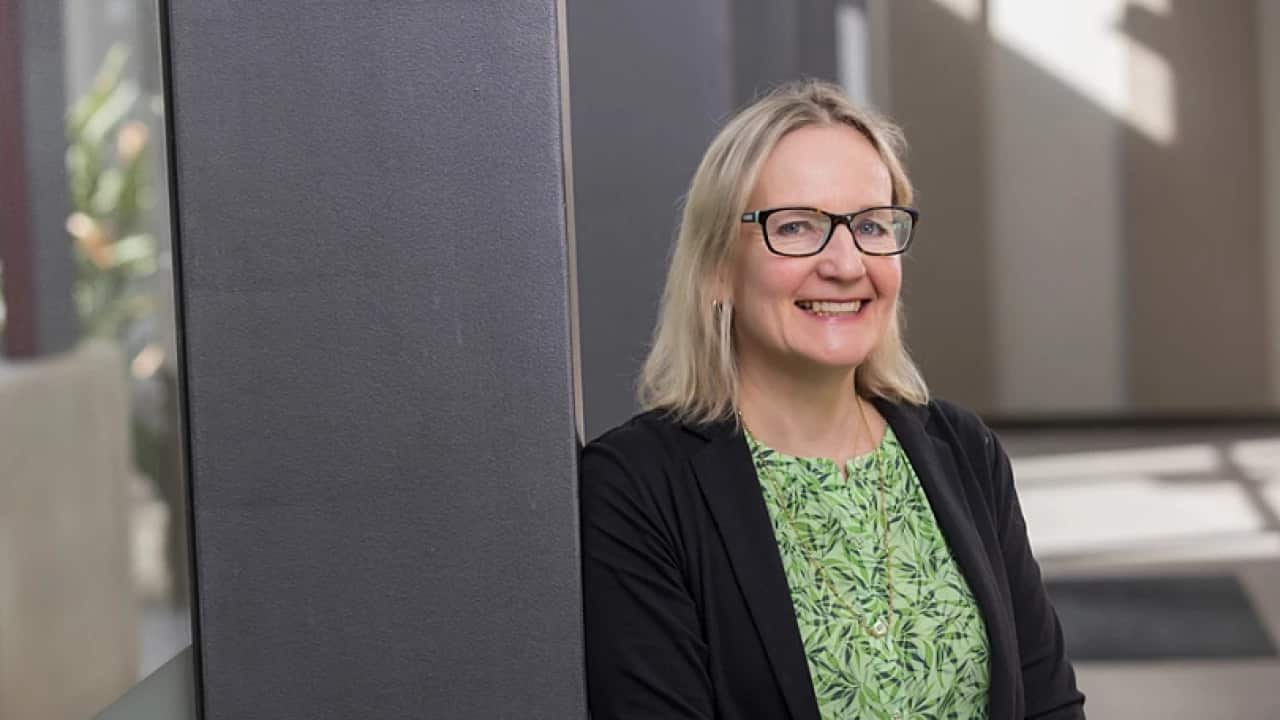 A woman smiling as she poses for a photo.