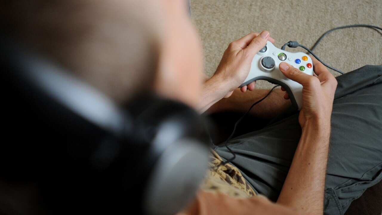A man plays an XBox video game in Sydney