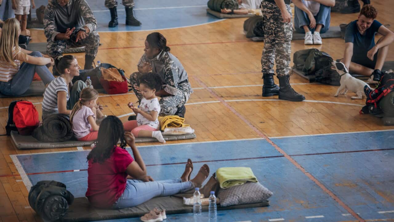Civilians with soldiers after natural disaster
