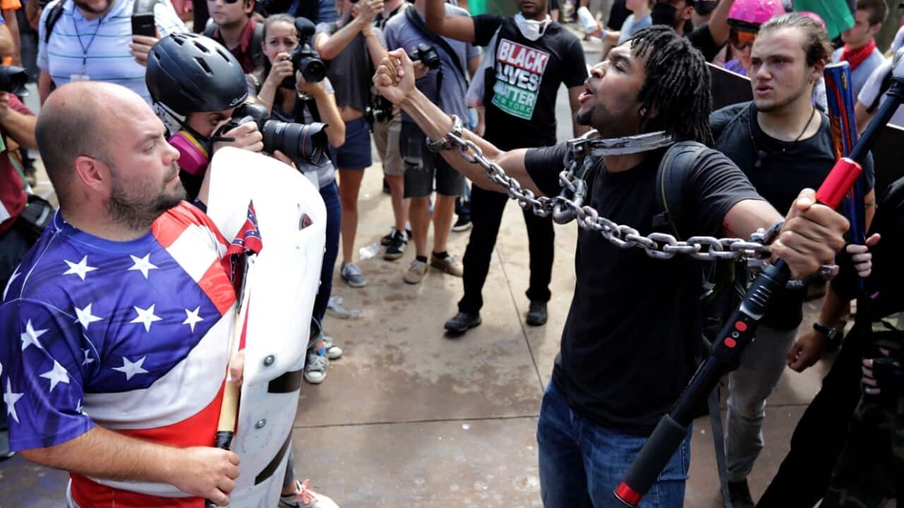 White nationalists, neo-Nazis and members of the 'alt-right' exchange insults with counter-protesters as they attempt to guard the entrance to Lee Park