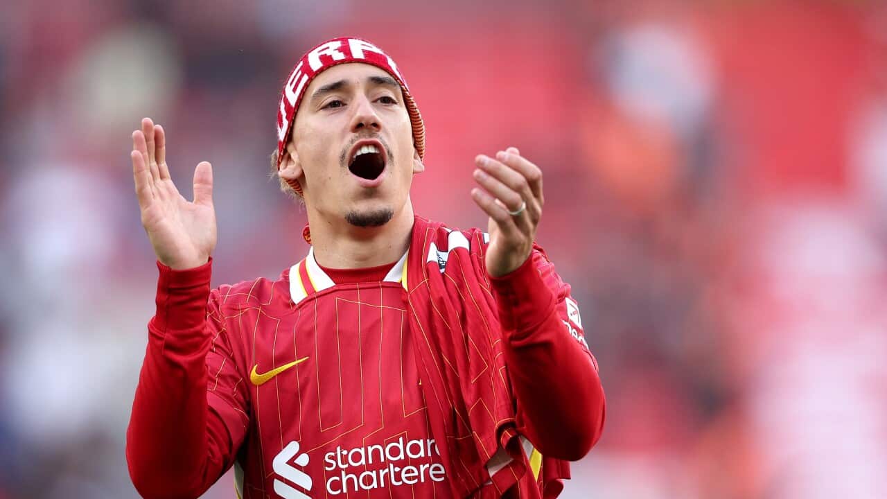 Liverpool player Konstantinos Tsimikas celebrates in front of fans after the English Premier League soccer match between Liverpool FC and Tottenham Hotspur, in Liverpool, Britain, 27 April 2025. Liverpool won 5-1 to win their 20th English league title