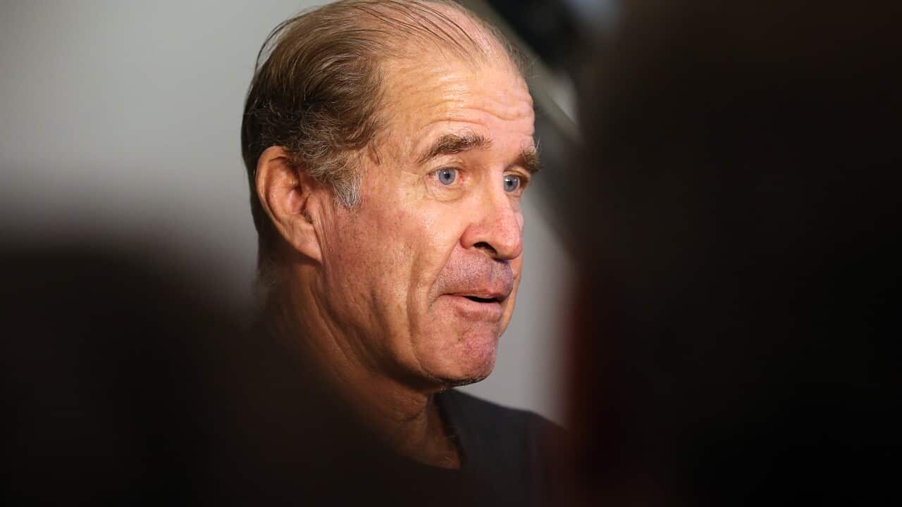 A close up of a man speaking