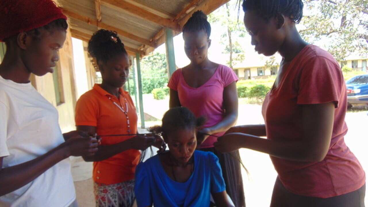 Selua Viola learning how to plait hair (ACAV, Uganda).jpeg