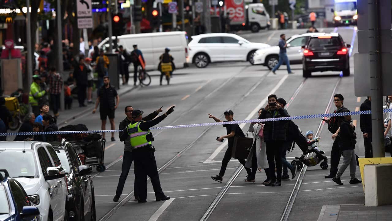 Police are seen redirecting pedestrians away from an incident on Bourke Street in Melbourne.