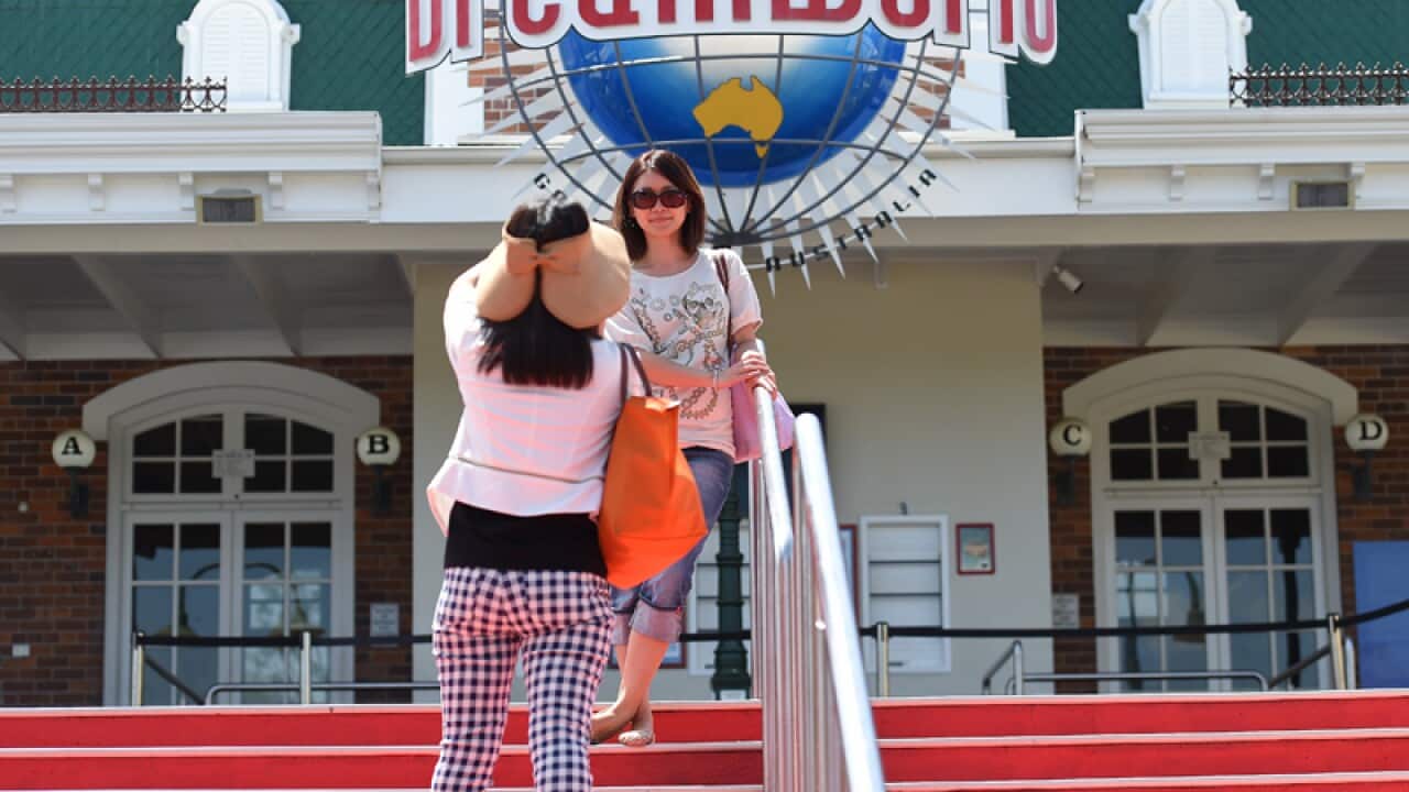 Tourist take photographs at the Dreamworld Theme Park