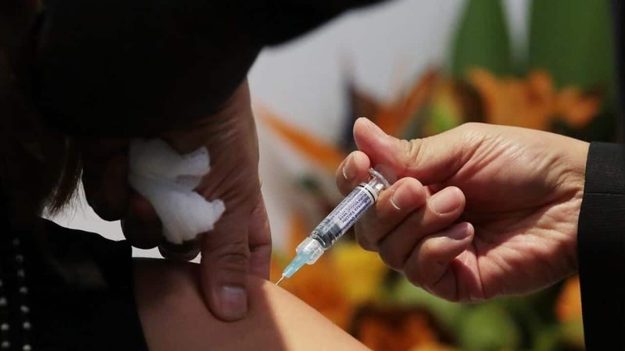 A member of the public receives a flu shot
