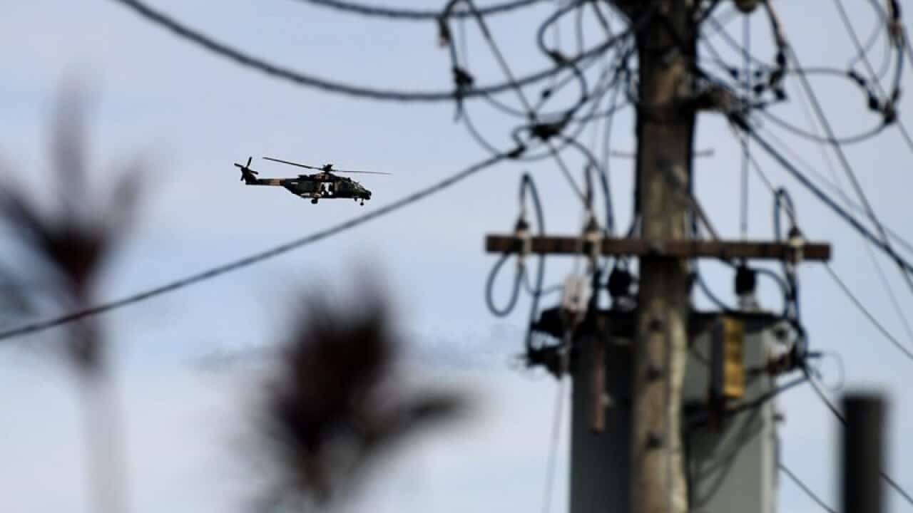 An army helicopter flies over Proserpine