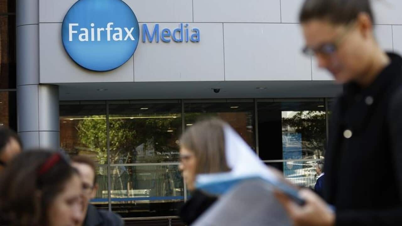 People walk by the exterior of the Fairfax Media office in Sydney.