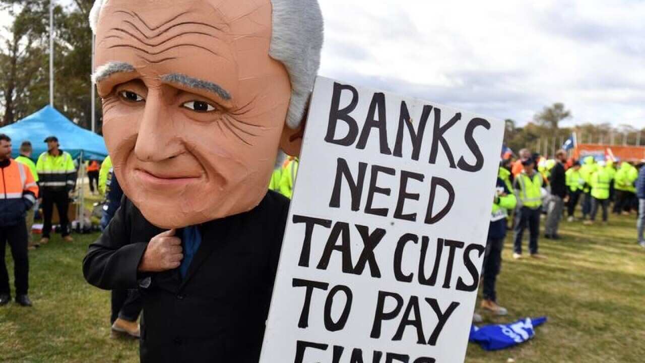 A man wearing a Malcolm Turnbull head