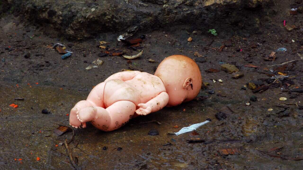 Almost one child dies every fortnight at the hands of a parent in Australia - Doll thrown on the dirty floor.
