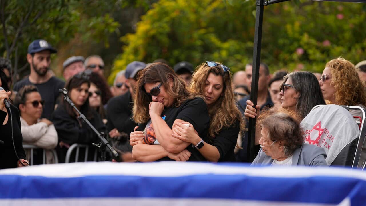 People cry at a funeral