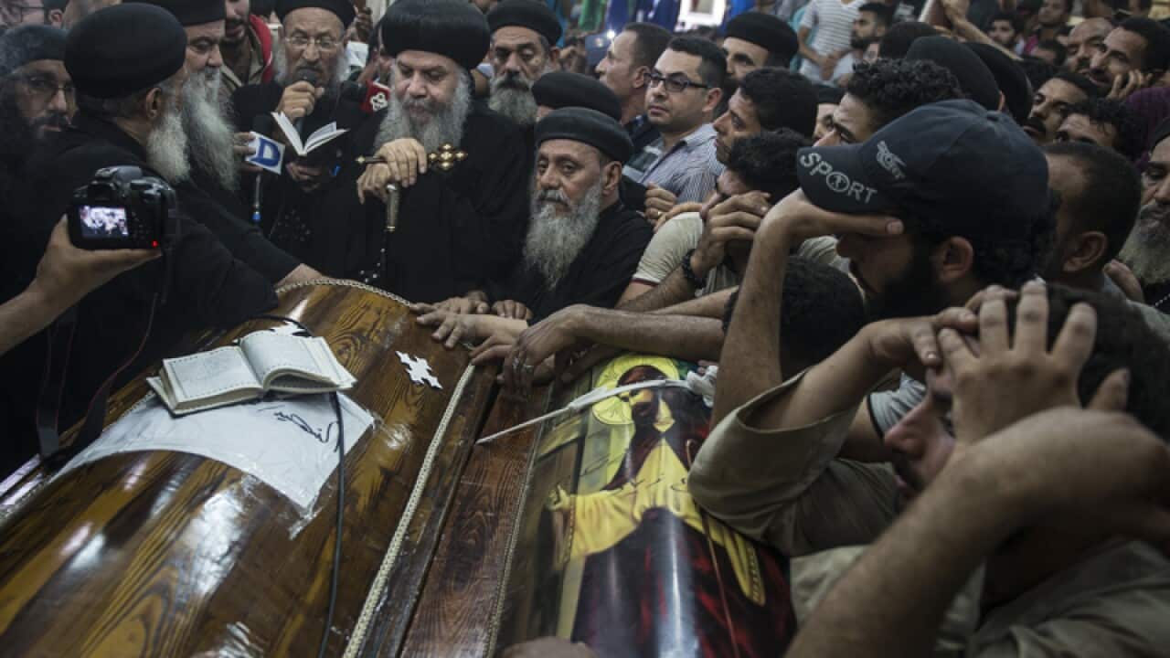 Coptic Christians attend funeral for victims of a deadly attack.