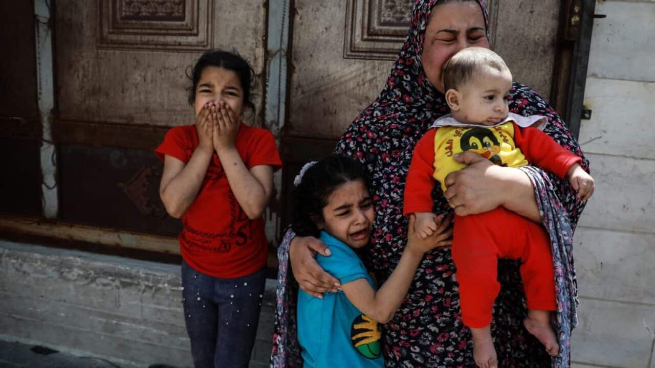 Palestinian women and children evacuated their homes and headed for shelter during an Israeli airstrike in Gaza City on 20 May..