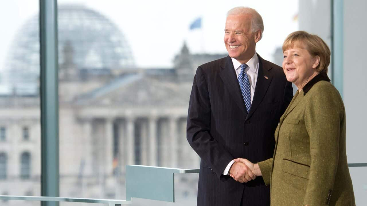 German Chancellor Angela Merkel shakes hands with then-US Vice President Joe Biden in 2013.