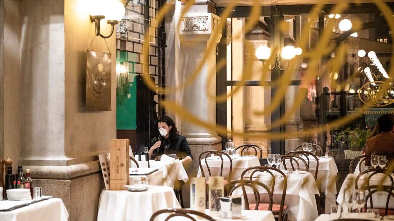 A tourist wears a protective mask at Biffi Restaurant in Galleria Vittorio amid coronavirus fears.